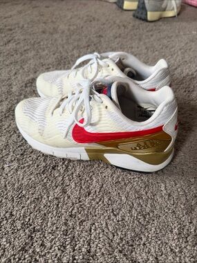 Nike White Sneakers with Red Swoosh and Gold Heel